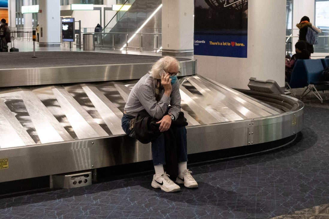 A traveller sits in baggage claim at LaGuardia Airport in New York on Christmas Eve. Photo: AFP