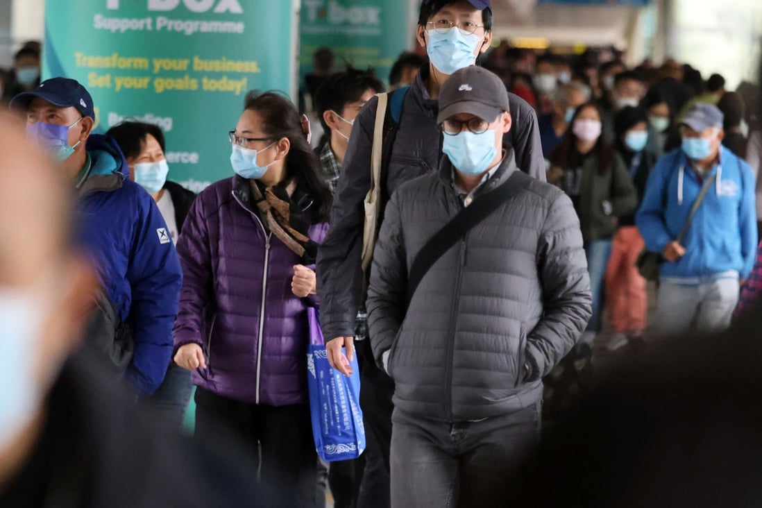 Pedestrians bundled up on Sunday as temperatures dropped to around 12 degrees Celsius, prompting a cold weather warning from the Hong Kong Observatory. Photo: Nora Tam