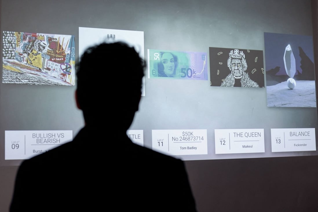 A visitor looks at NFT digital artworks at the Millon Belgique auction house, in Brussels on May 18, 2021. Photo: AFP