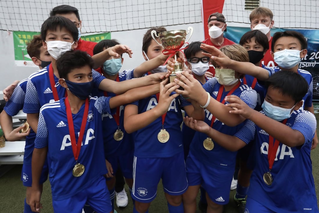 Members of HKFC1 celebrate winning the cup final of the U12 tournament at Happy Valley Recreation Ground. Photo: Jonathan Wong