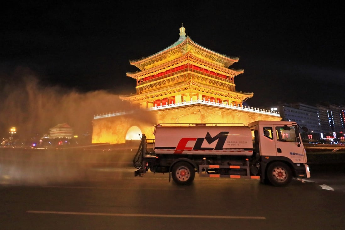 Ein Desinfektionsfahrzeug bei der Arbeit am Sonntagabend in der Nähe des Glockenturms von Xian, während Beamte in der nordwestchinesischen Stadt einen Covid-19-Ausbruch bekämpfen.  Foto: Getty Images