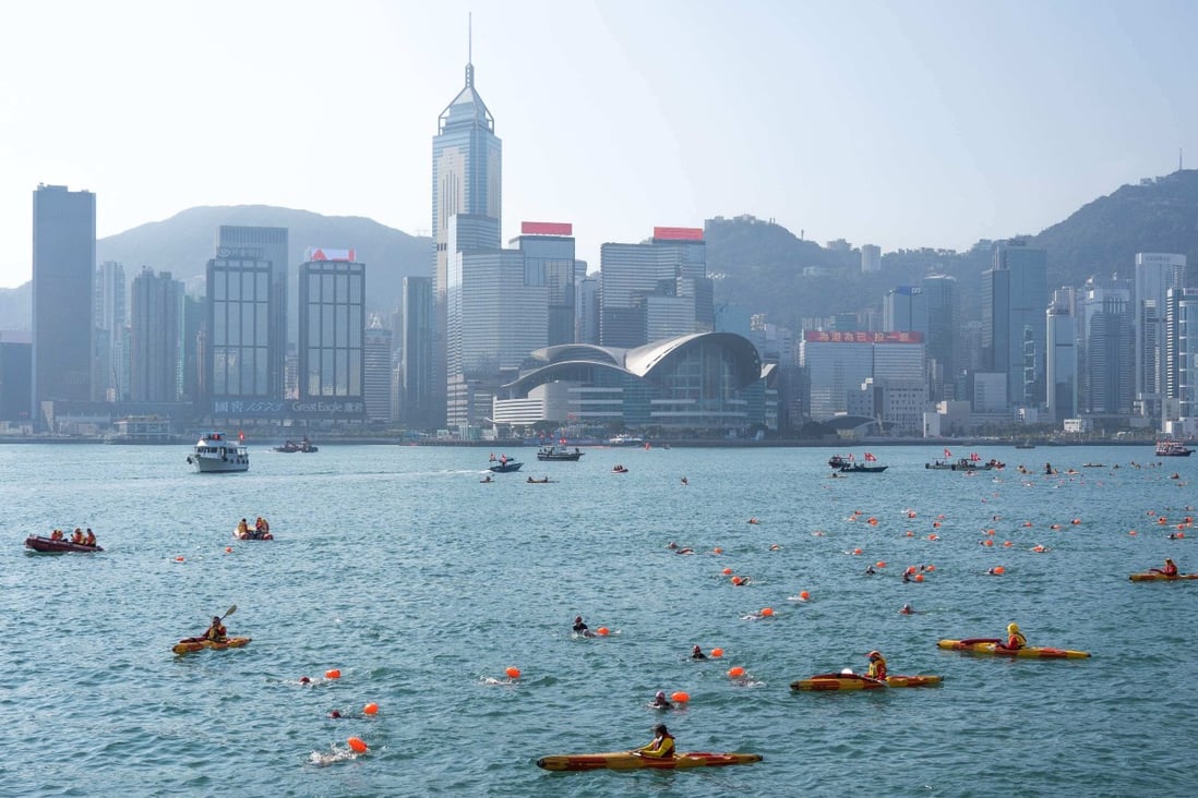 Swimmers swim across Victoria Harbour during an annual race in Hong Kong on December 12. Place and street names that reflect the city’s heritage should be embraced, not abandoned. Photo: AFP