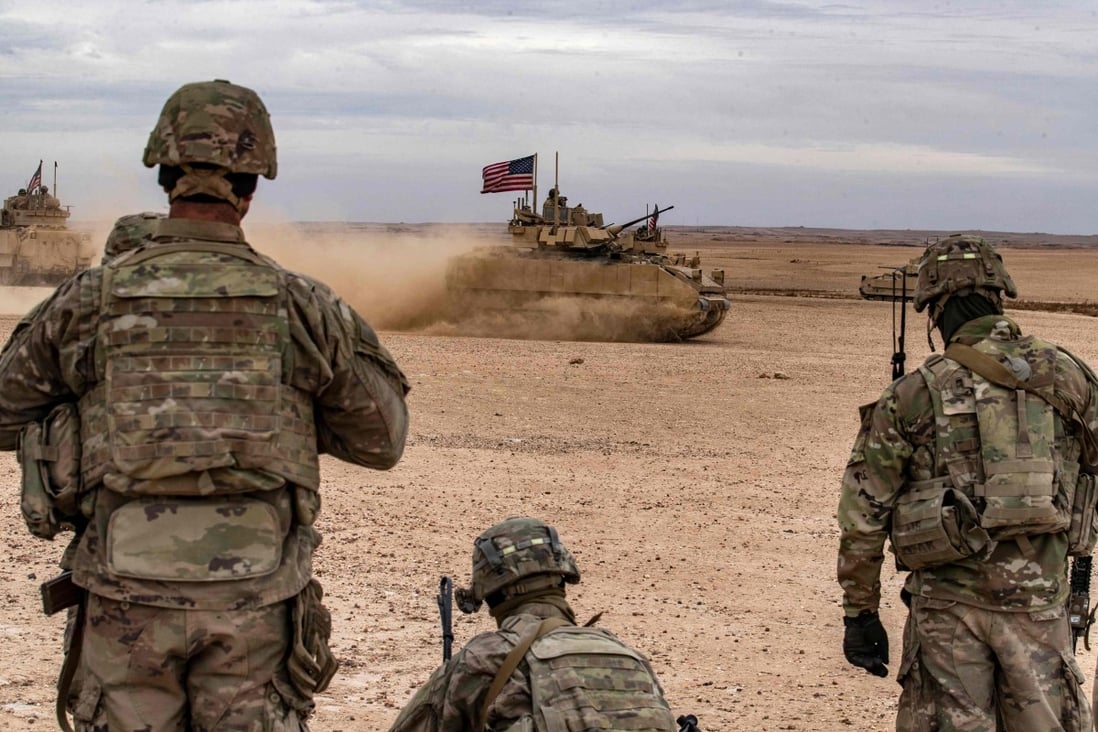 US soldiers watch an armoured vehicle flying an American flag during a joint military exercise with allied forces in Syria earlier this month. Photo: AFP