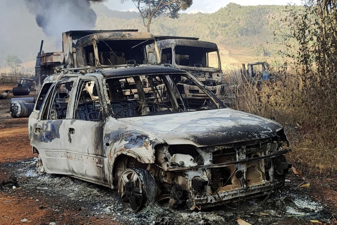 In this photo provided by the Karenni Nationalities Defense Force (KNDF), vehicles smolder in Hpruso township in the Myanmar state of Kayah on December 24 following what witnesses said was an attack by Myanmar troops, who allegedly fatally shot more than 30 villagers and set the bodies on fire. Photo: KNDF via AP
