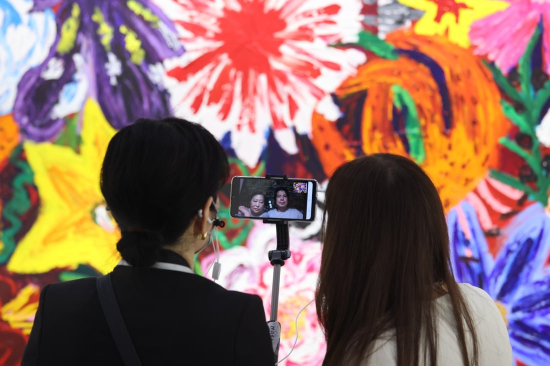 Visitors live-stream while attending Art Basel Hong Kong 2021 at the Hong Kong Convention and Exhibition Centre in Wan Chai on May 19. Photo: Nora Tam