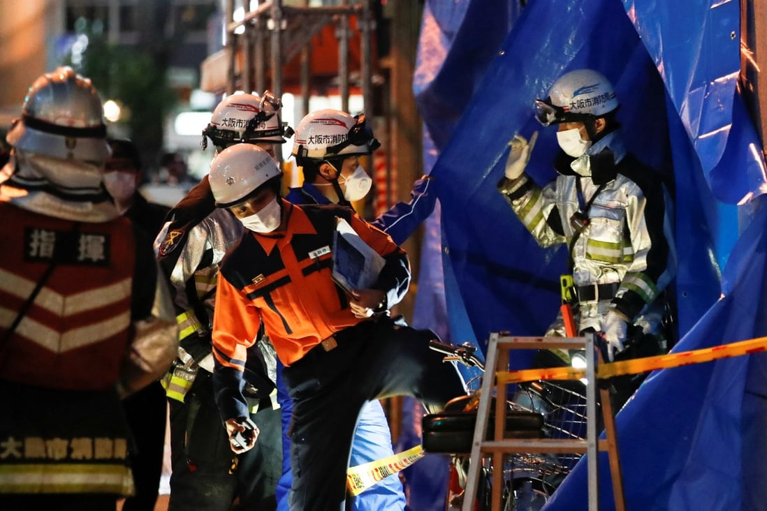 Firefighters work outside a building where a fire broke out in Osaka, Japan on December 17. Photo: Reuters
