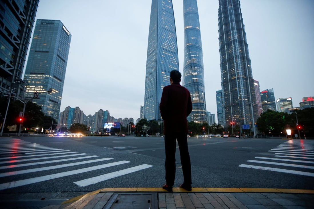 A man stands at a crossroads in Lujiazui financial district in Shanghai in March 2021. Photo: Reuters