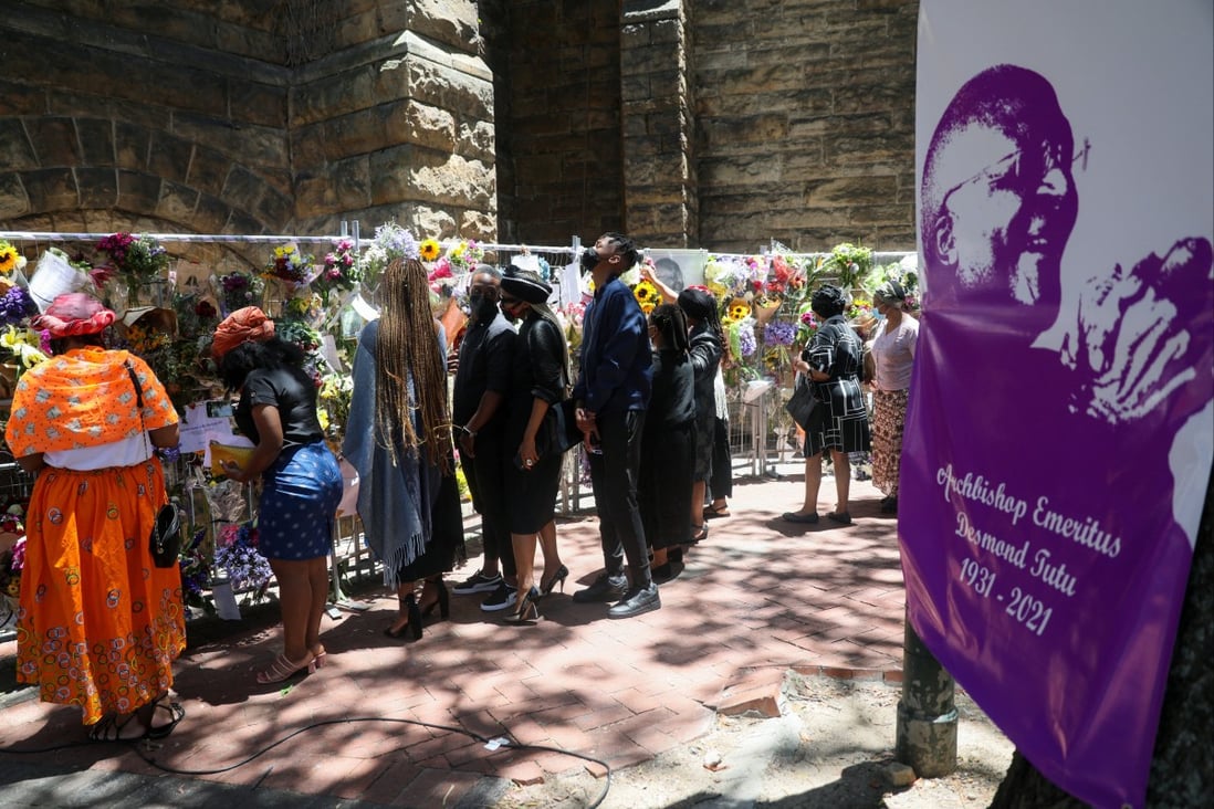 Family members of the late Archbishop Desmond Tutu walk past a remembrance wall of flowers and condolence messages outside St George’s Cathedral in Cape Town, South Africa on December. Photo: Reuters