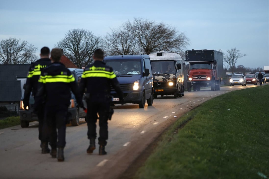Police officers check cars leaving the site of a brick factory in Rijswijk, Netherlands, where an illegal party was held on New Year’s Day. Photo:  EPA-EFE
