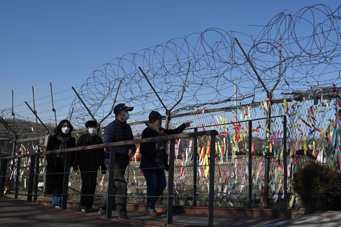 Visitors walk past a military fence decorated with ribbons wishing for peace and reunification of the Korean Peninsula at Imjingak peace park near the demilitarized zone dividing the two Koreas. Photo: AFP