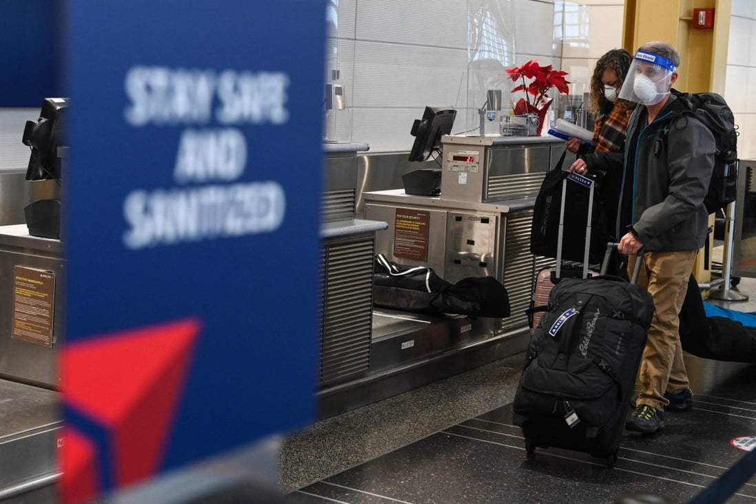 Passengers push their luggage in the check-in area of Ronald Reagan International Airport in Washington, DC. Photo: AFP