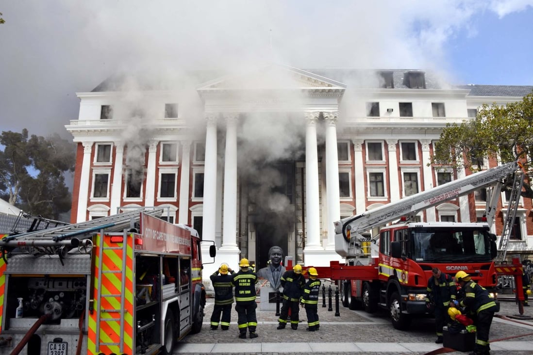 Firefighters work after a fire broke out in the parliament in Cape Town, South Africa on January 2. Photo: Elmond Jiyane / GCIS / Handout via Reuters