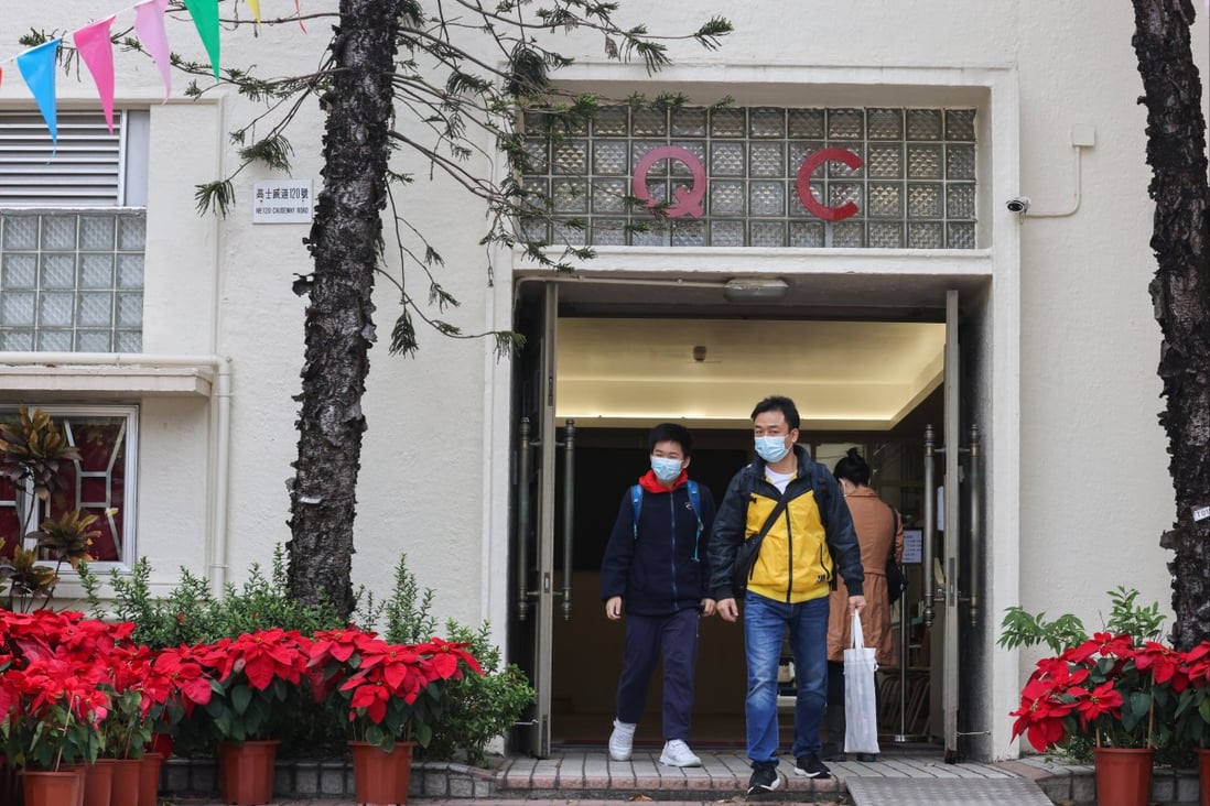 A father and his son at Queen’s College in Causeway Bay on Monday, the first day of the discretionary place admission exercise for Form One students. Photo: Nora Tam