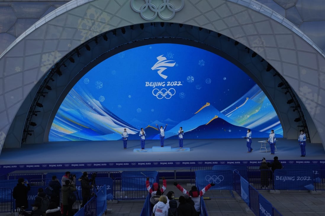Staff members rehearse a victory ceremony at the Beijing Medals Plaza. Photo: AP