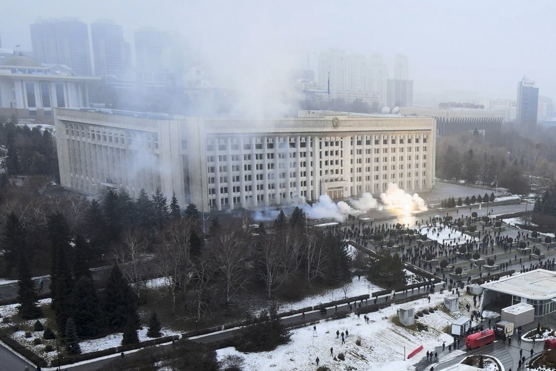Smoke rises from the city hall building during a protest in Almaty, Kazakhstan, on Wednesday. There are reports that protesters angry about rising fuel prices broke into the mayor’s office in the country’s largest city and flames were seen coming from inside. Kazakh news site Zakon said many demonstrators who converged on the building  carried clubs and shields. Photo: AP