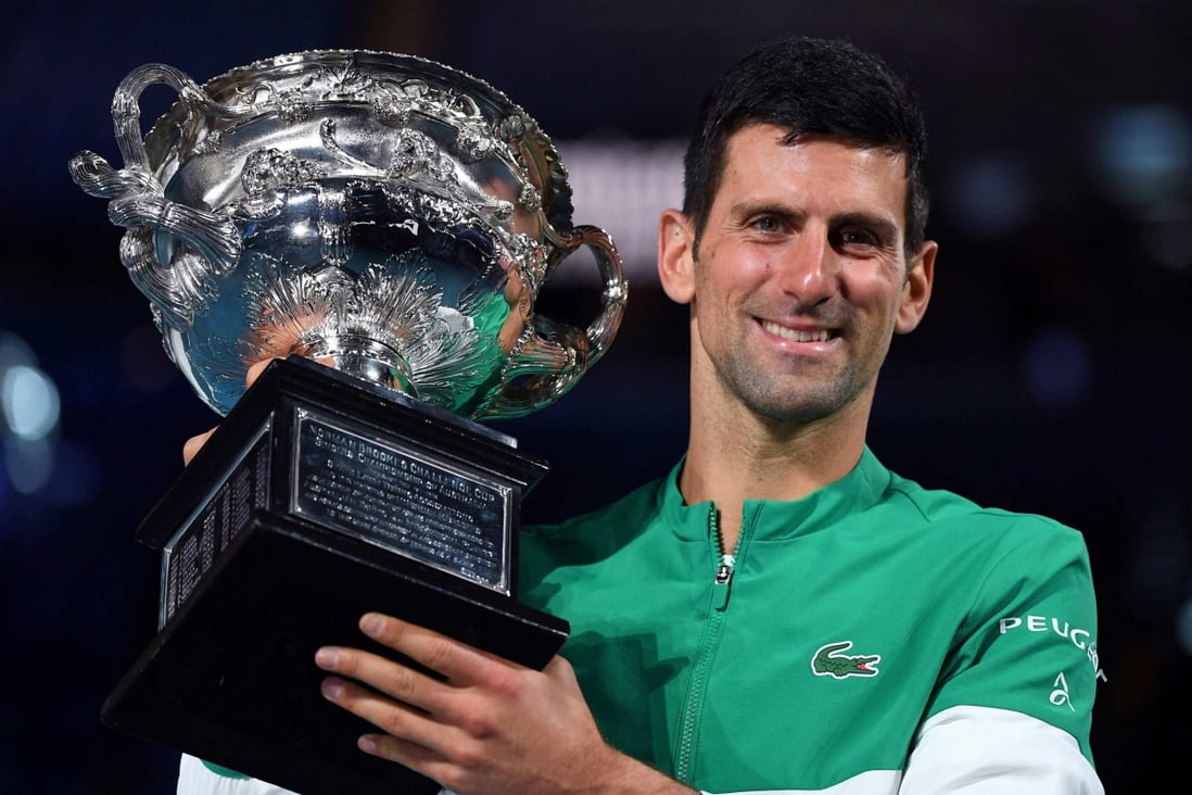 Serbia’s Novak Djokovic poses with the Norman Brookes Challenge Cup trophy following his victory against Russia’s Daniil Medvedev in their men’s singles final match on day fourteen of the 2021 Australian Open. Photo: AFP
