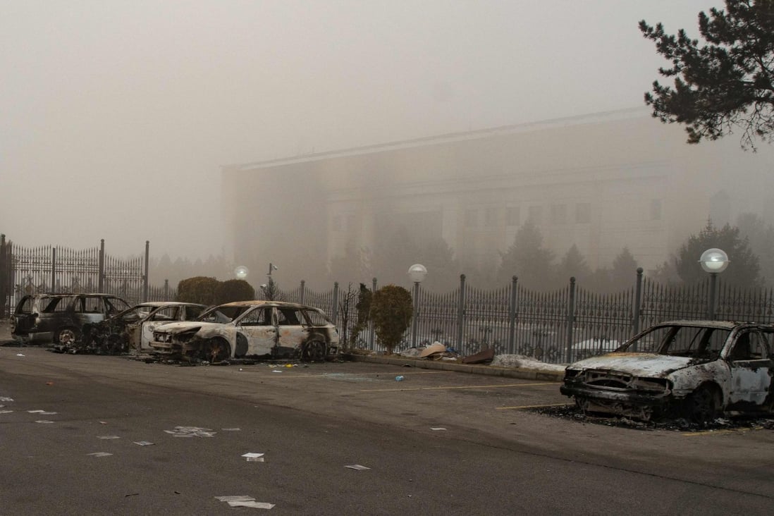 Burnt-out cars at a parking area near administrative buildings in central Almaty. Photo: AFP