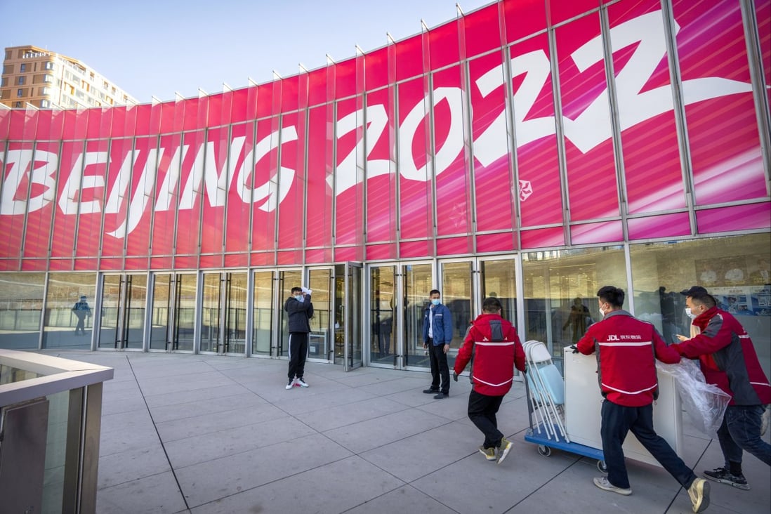 Workers deliver equipment to the Olympic Village in Beijing. Photo: AP