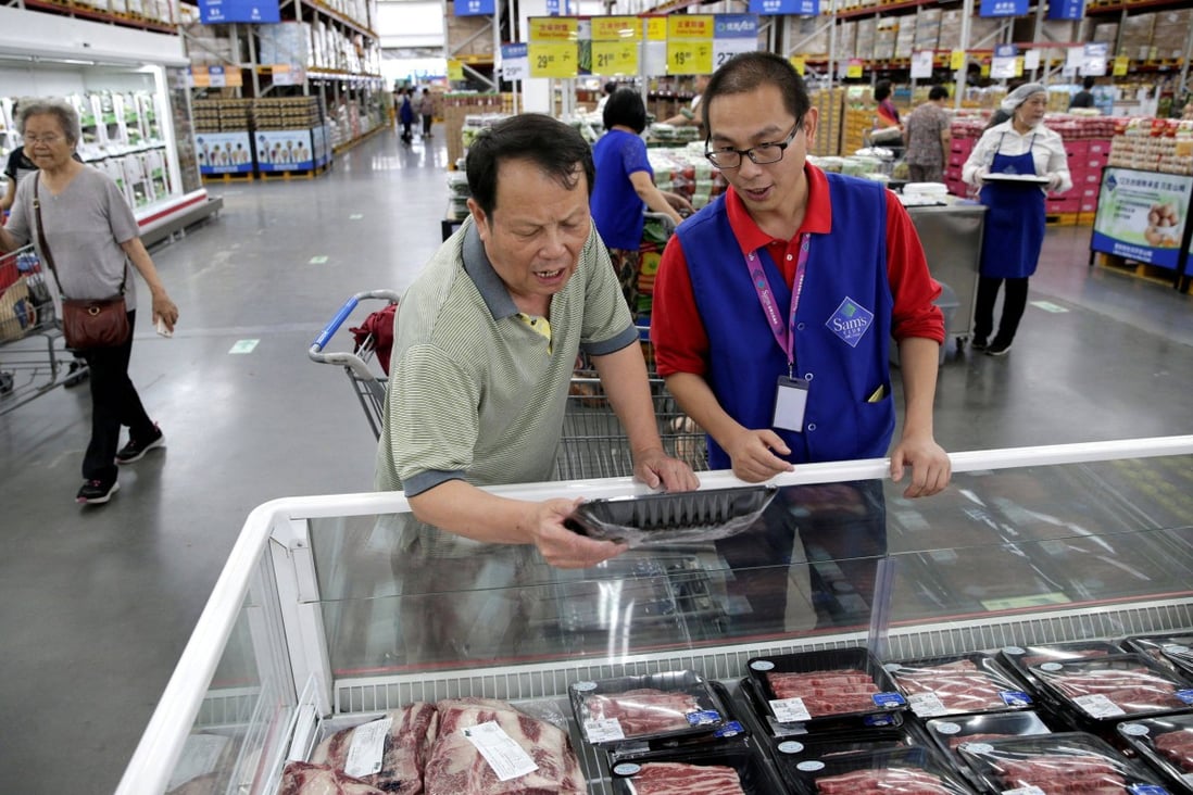 A customer checks the beef steaks at a Sam’s Club store of Wal-Mart in Beijing, China. Photo: Reuters 