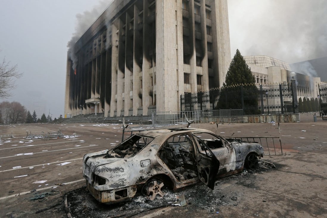 A burned car in front of the mayor’s office which was torched during protests triggered by fuel price increase in Almaty. Photo: Reuters
