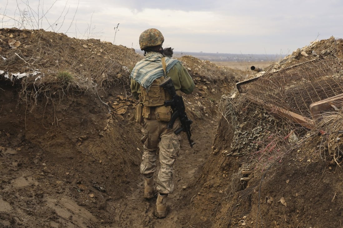 A Ukrainian soldier holding a cat walks in a trench on the line of separation from pro-Russian rebels in the Donetsk region of Ukraine. With the fate of Ukraine and potentially broader post-Cold War European stability at stake, the US and Russia are due to start critical talks that could shape the future of their bilateral ties and the relationship between the US and its Nato allies. Photo: AP
