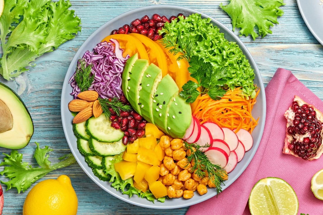 Buddha bowl salad with avocado, tomato, lettuce, cucumber, red cabbage, chickpeas,  almonds, carrots, yellow pepper, radish and pomegranate. January is also referred to as Veganuary, when many people switch to a whole food plant-based diet. Photo: Shutterstock