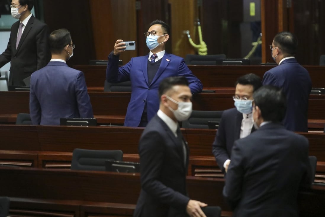 Lawmaker Chan Han-pan (centre) takes a photo after the question and answer session at the Legislative Council on Wednesday. Photo: Sam Tsang