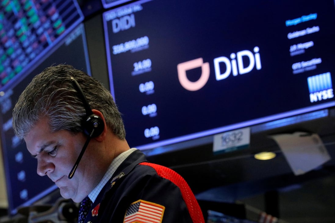 Didi’s logo behind a floor trader at the New York Stock Exchange (NYSE) on June 30, 2021. Photo Reuters.
