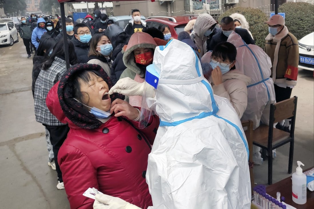 A medical worker takes swab samples for the COVID-19 test on residents in Hua county in central China’s Henan province on Monday. Photo: AP