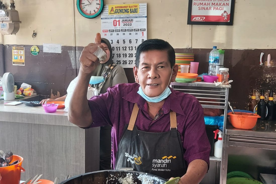 Fery, 60, on another busy day in Indonesia’s Medan cooking a variety of dishes including soto ayam soup. Photo: Aisyah Llewellyn 