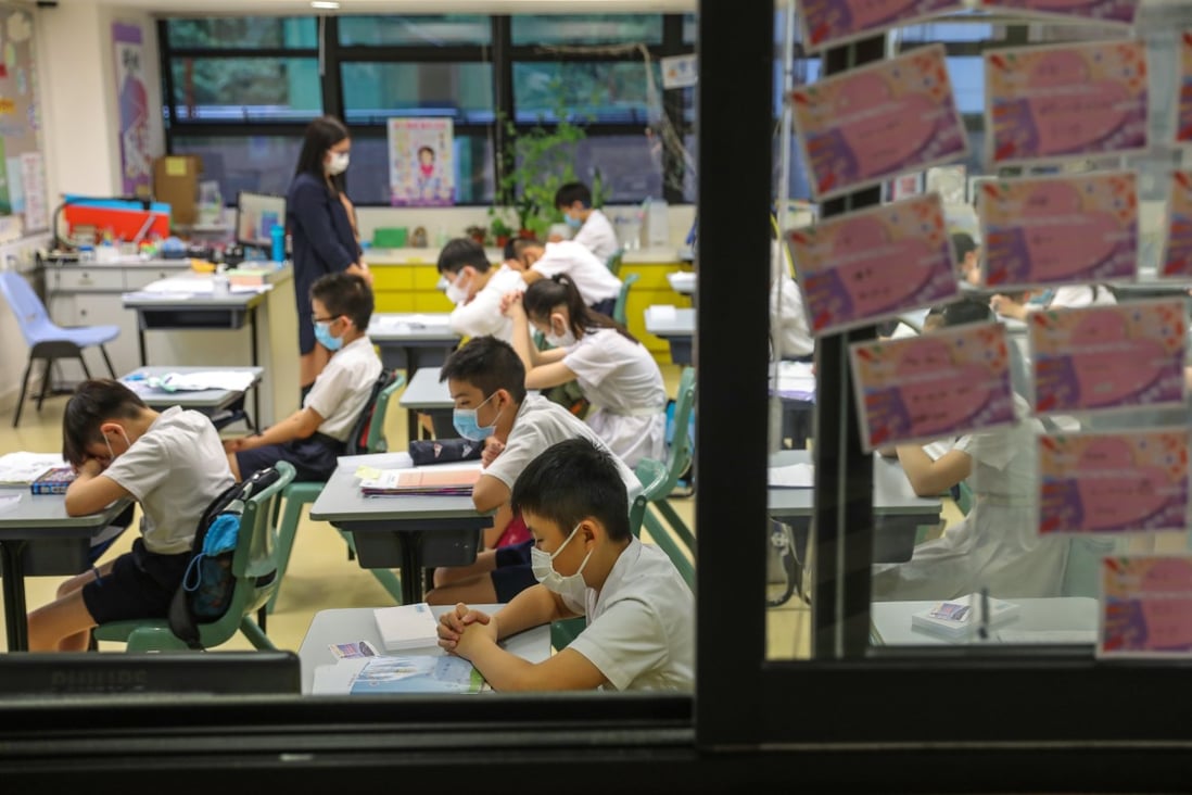 Students and teachers of S.K.H. St. James’ Primary School in Wan Chai pray for the easing of the coronavirus situation in Hong Kong on June 8, 2020. Photo: Nora Tam