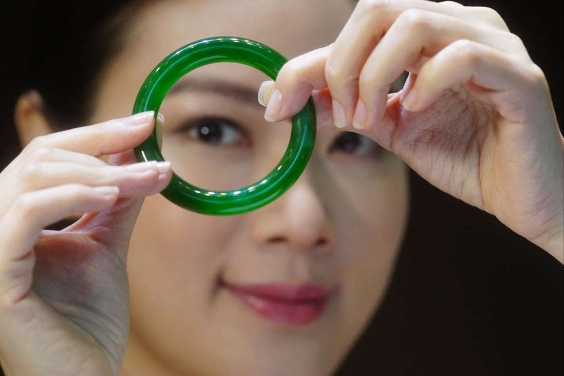 A model displays a jadeite bangle during a media preview of Sotheby’s spring auctions in March 2021. The bangle was auctioned off for just over HK$30 million (US$3.8 million).