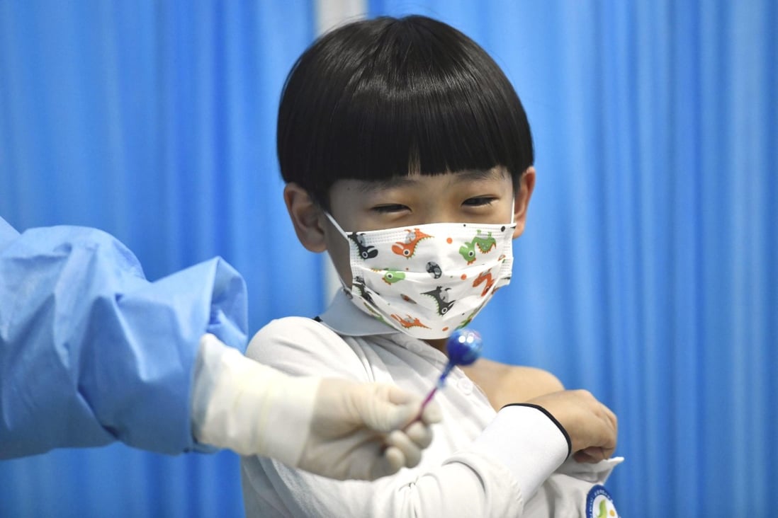 A boy gets a lollipop from a medical worker after receiving a dose of Covid-19 vaccine in Tianjin, China. Photo: Xinhua