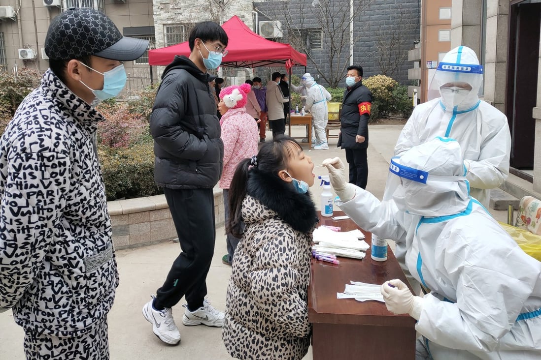 Medical workers swab residents in Huaxian, a county in Henan province, during a third round of mass testing on Wednesday. Photo: Chinatopix via AP