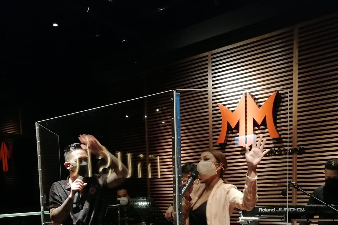 A performance at MM, a live music venue in Hong Kong’s Central that has since closed down. Government rules require singers to wear masks and perform behind a partition. Photo: Babe Tree