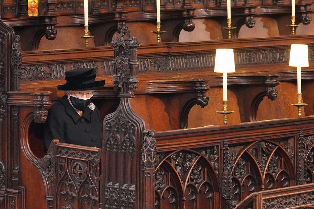 Queen Elizabeth sits alone, in one of the most striking images from the funeral of her husband, Prince Philip, in St George’s Chapel at Windsor Castle in April. Photo: TNS