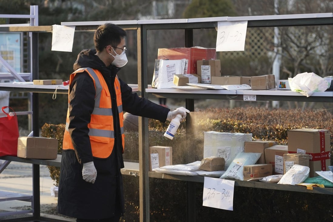 Parcels are sprayed with disinfectant in Beijing’s Haidian district. Photo: AP