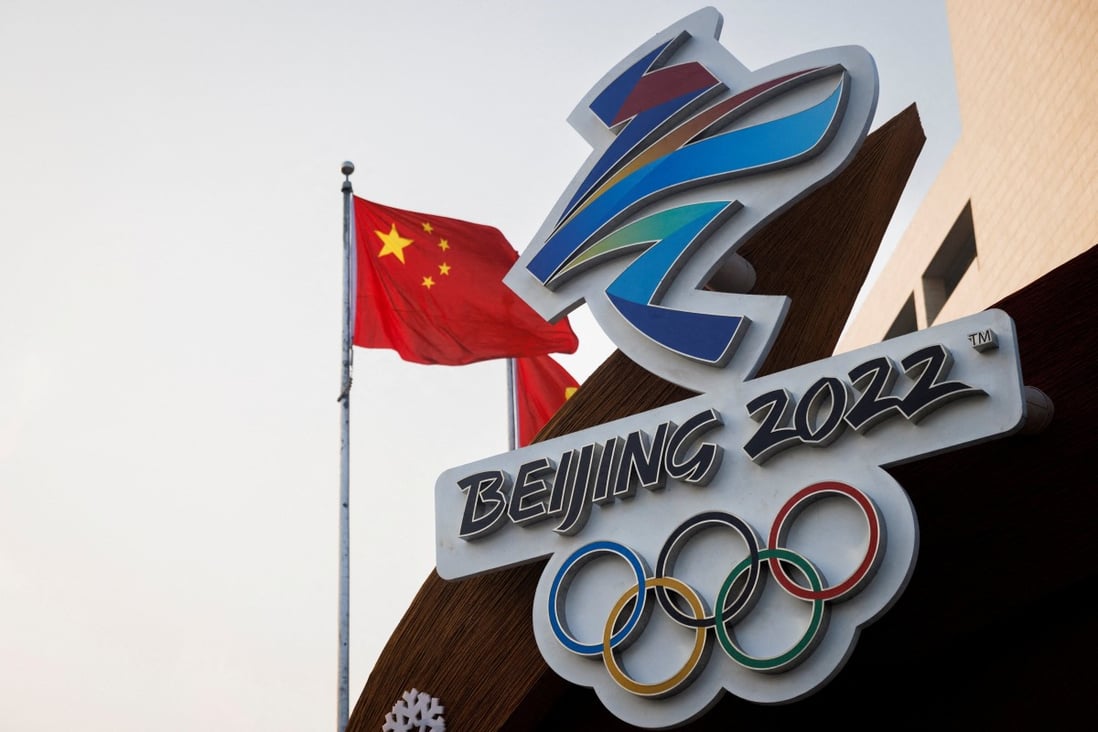The Chinese national flag flies behind the logo of the Beijing 2022 Winter Olympics. Photo: Reuters