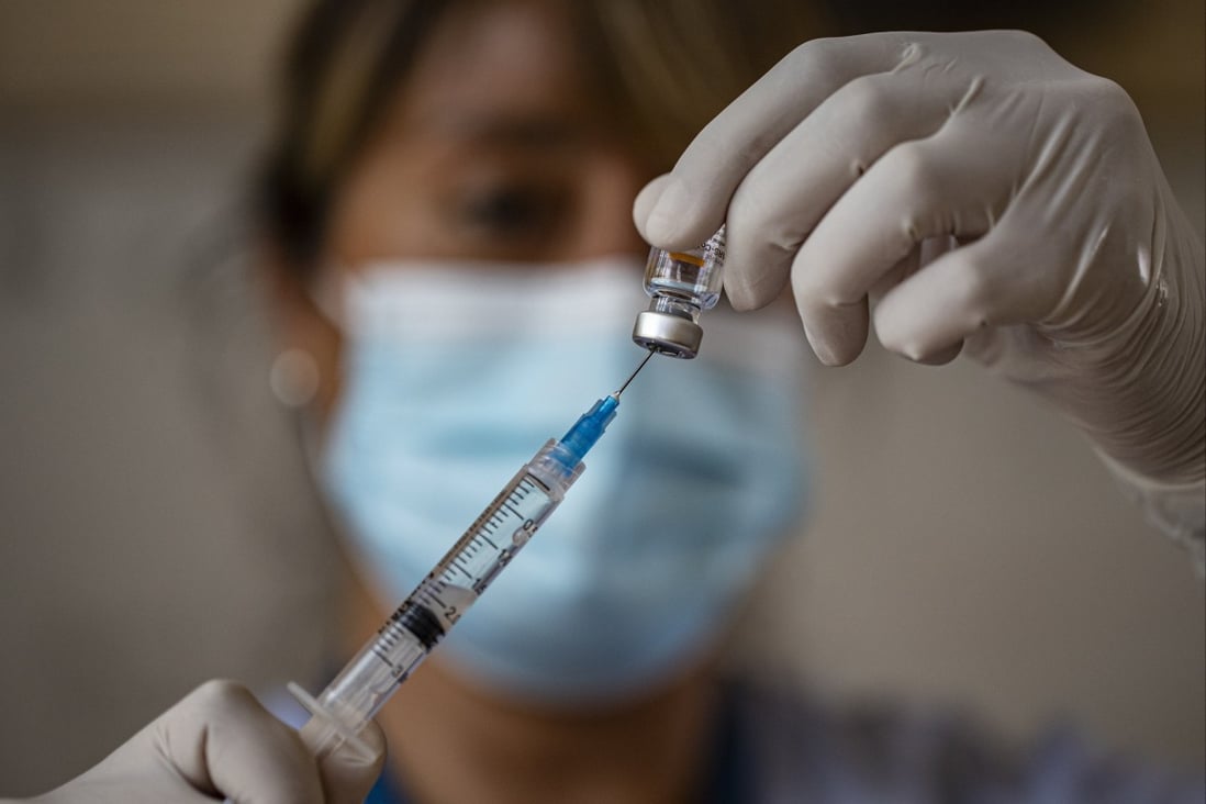 A health care worker prepares a dose of Sinovac’s Covid-19 vaccine at the Salvador Sanfuentes public school in Santiago, Chile. While doubts have been raised about inactivated vaccines like CoronaVac, immunity should be measured in terms of cellular immunity, not antibody count. Photo: AP 