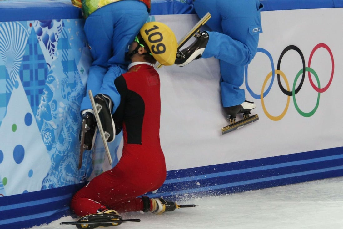 Olympic officials who maintain the ice jump out of the way as China’s Fan Kexin crashes into the barrier in the women’s 500 metres short track speed skating semi-finals during the 2014 Sochi Winter Olympics. Photo:       Reuters/David Gray