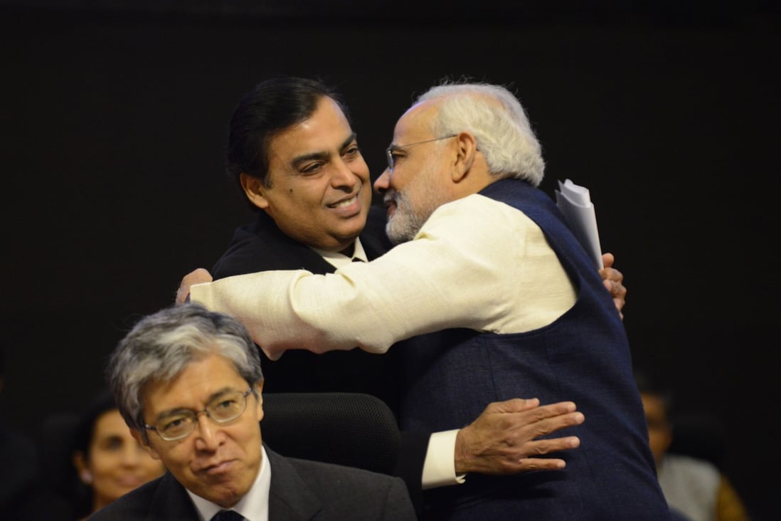 Narendra Modi, now India’s prime minister and then-chief minister of Gujarat state, embraces Mukesh Ambani in 2013. Photo: AFP