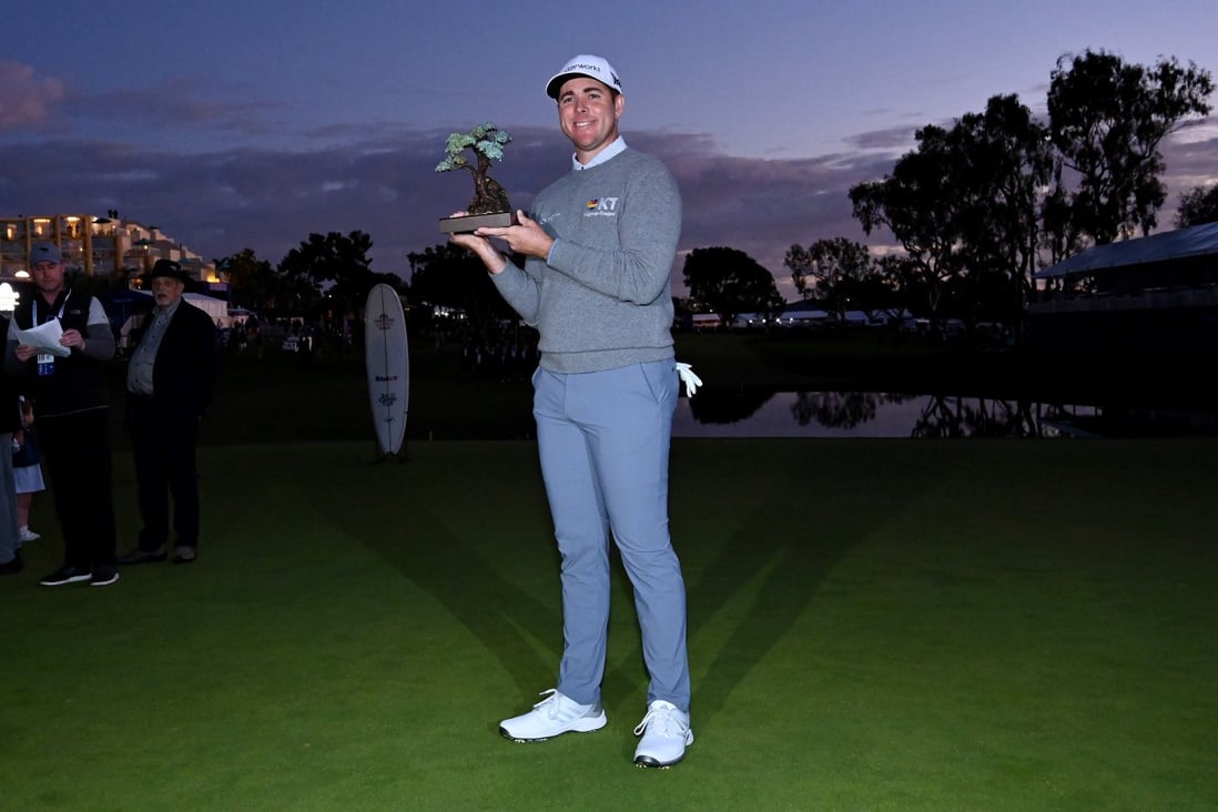 Luke List celebrates with the trophy after winning the The Farmers Insurance Open. Photo: TNS