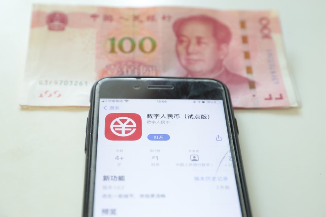 The e-CNY app seen on a mobile phone beside Chinese paper currency, January 6, 2022. Photo: EPA-EFE