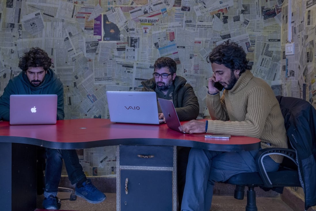 Fahad Shah, right, seen at work inside the Kashmir Walla newsroom in Srinagar last month. Photo: AP