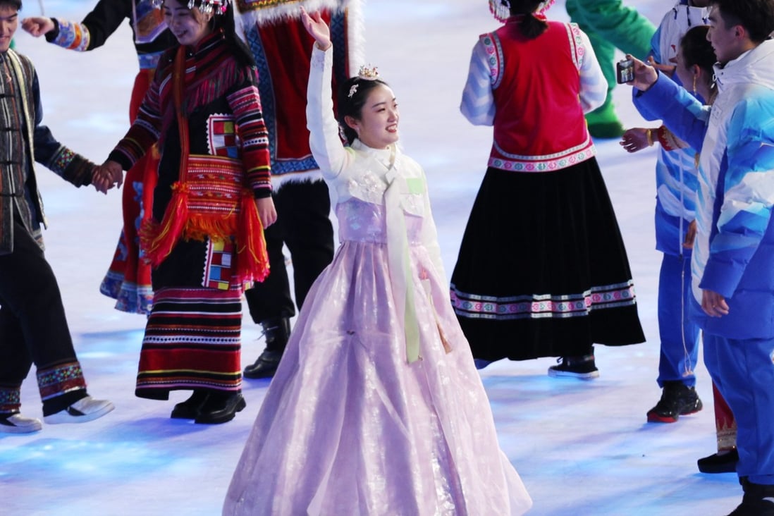 A performer in traditional Korean hanbok waves during the opening ceremony of the Beijing 2022 Winter Olympics on Friday. Photo: EPA