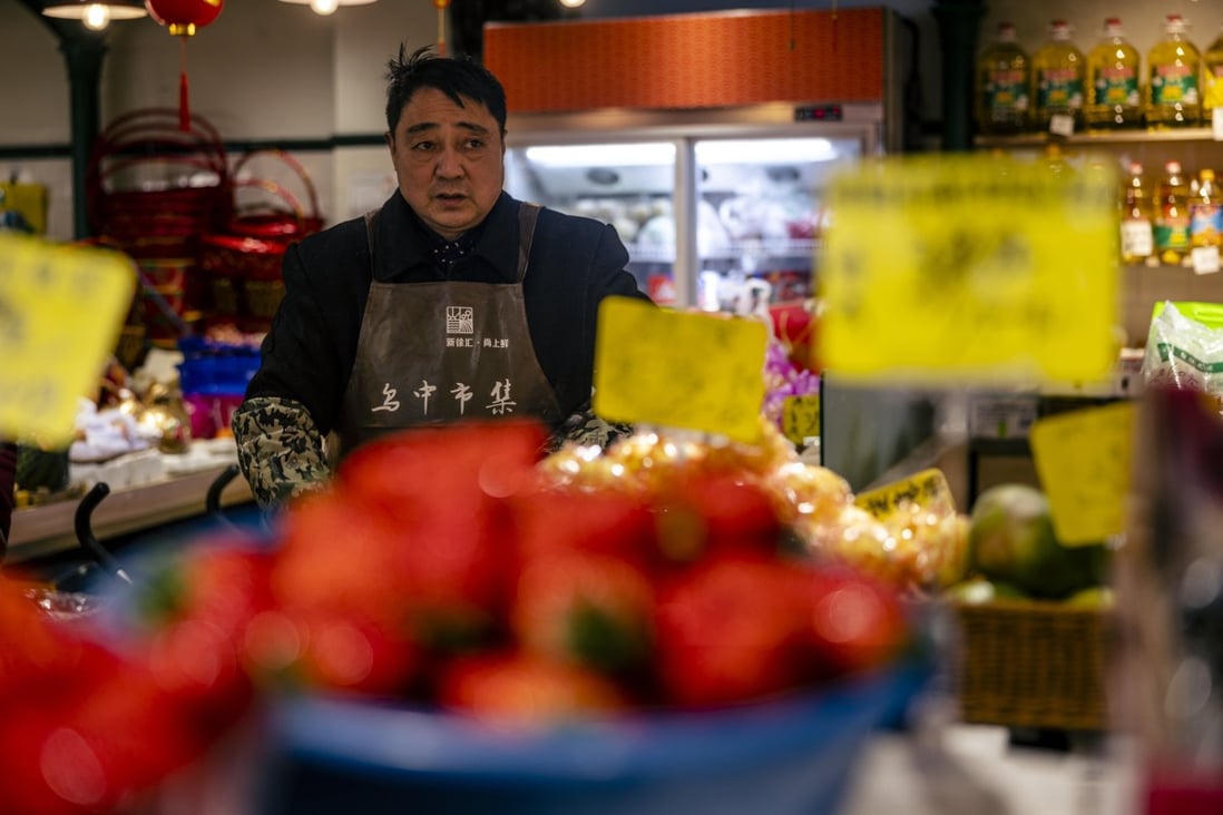 A man sells food in a wet market in Shanghai on January 11. China has a long history of high inflation and the recent two decades of low inflation is really an aberration. Photo: EPA-EFE 
