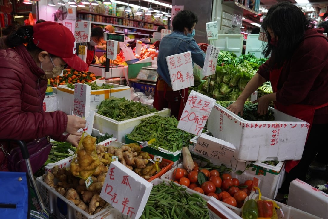 People buying fruits and vegetables at a wet market at North Point, Hong Kong. Photo: Sam Tsang