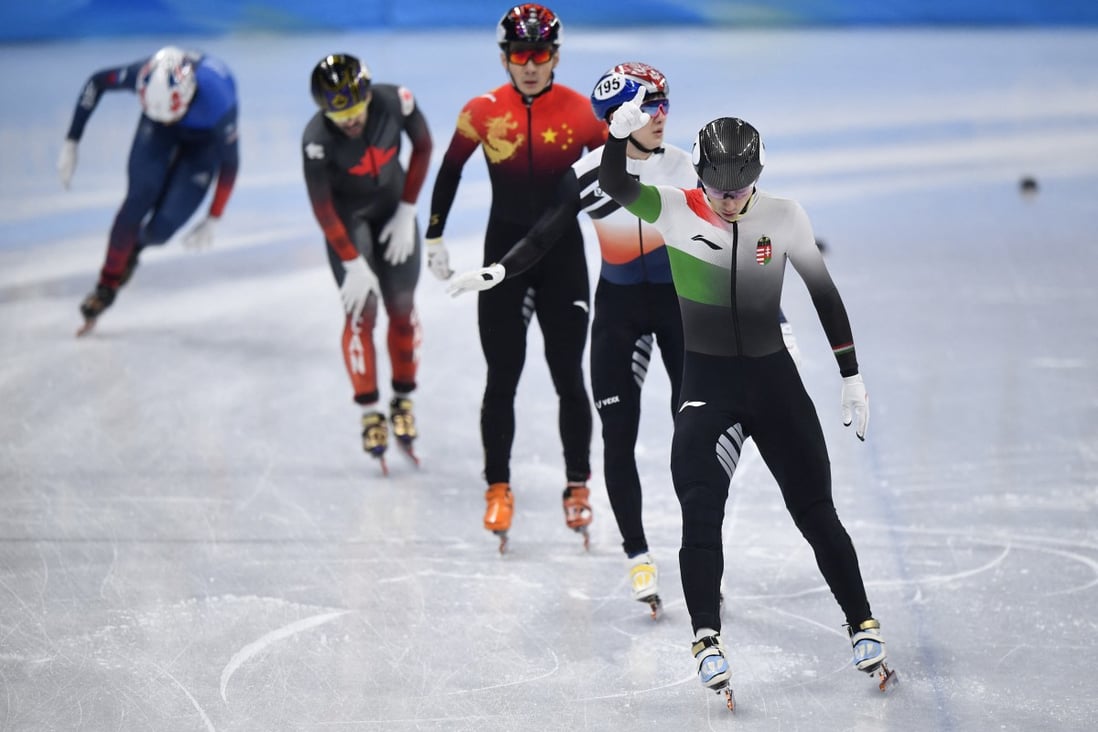 Shaoang Liu (front), Park Janghyuk, and Ren Ziwei cross the line at the end of their short-track speedskating 1,000m semi-final. Photo: Reuters