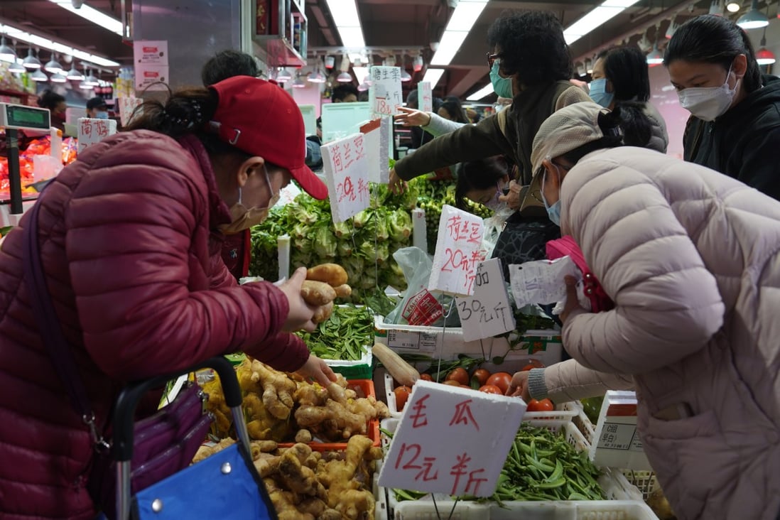 People buy vegetables and fruit at a wet market in North Point on February 8. Vegetable supplies in Hong Kong have been tight because of transport disruptions at the mainland border. Photo: Sam Tsang