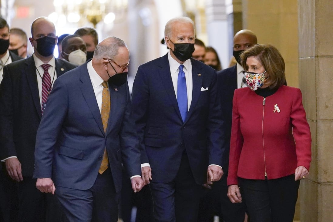 President Joe Biden is flanked by Senate Majority Leader Chuck Schumer of New York, left, and House Speaker Nancy Pelosi of California, right, after arriving on Capitol Hill in Washington on January 6, 2022.  Photo: AP